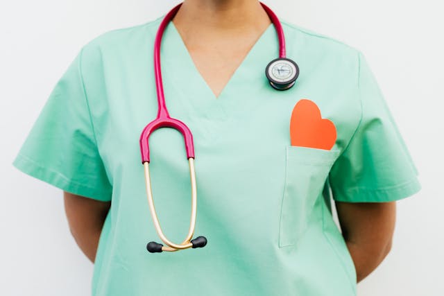 doctor with paper heart in her pocket