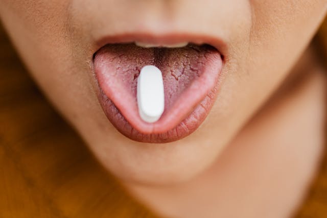wpman with pill in her mouth