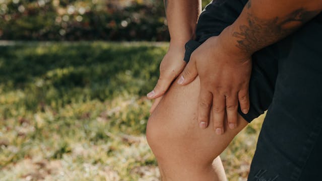 man holding leg