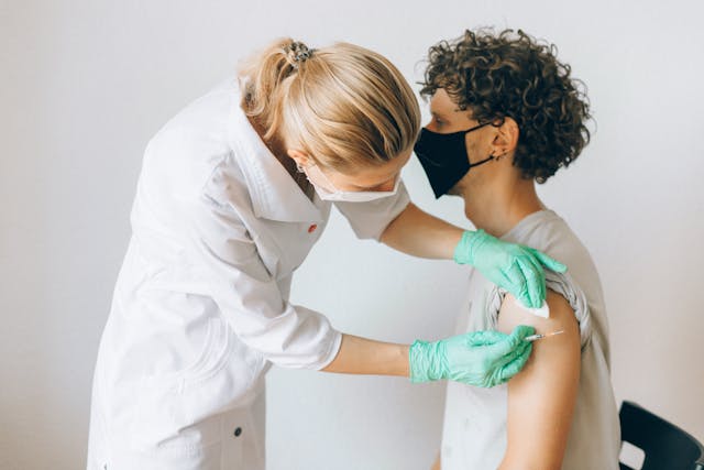 Person receiving a vaccine shot