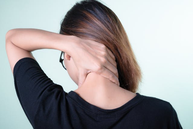 Woman holding her neck