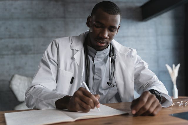 doctor writing in book