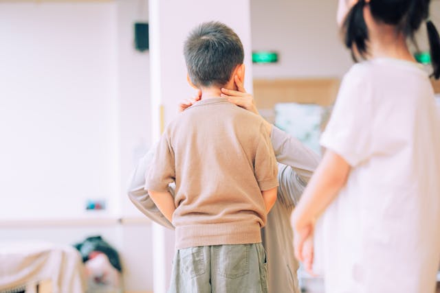 nurse examining young boy