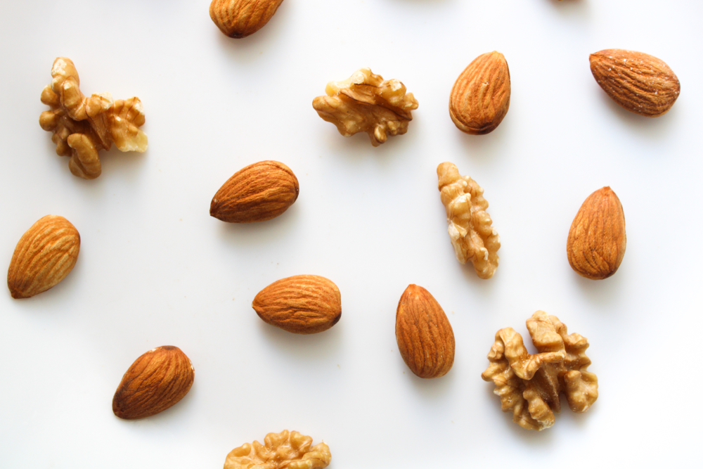 nuts mix on white backgrouns almonds and walnuts top view