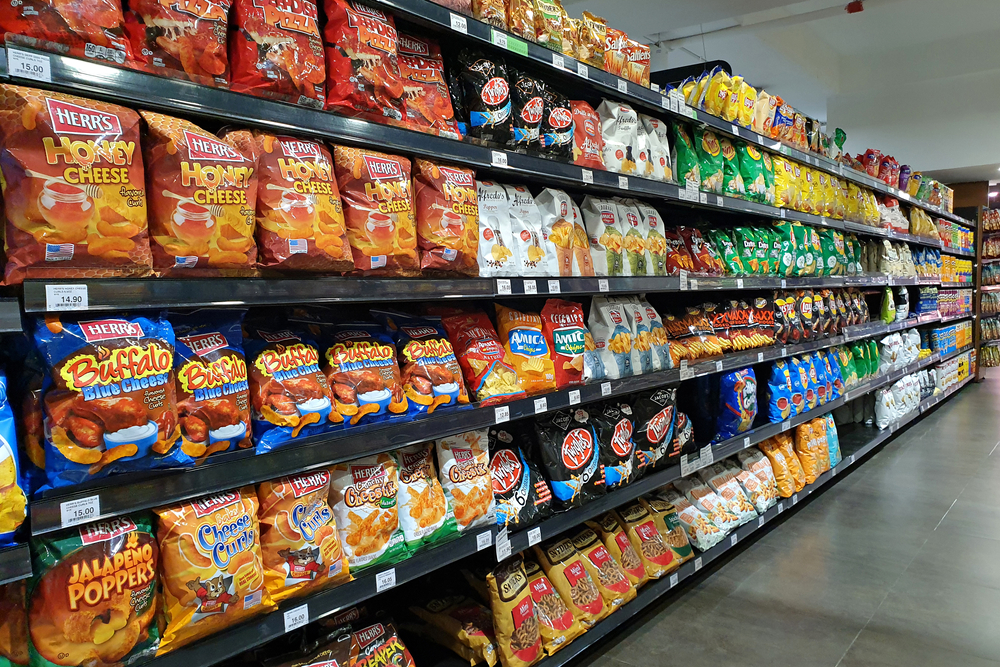 PENANG, MALAYSIA - 8 MAR 2021: Various local and imported brand of flavoured chips and snacks on store shelf in Mercato grocery store. Mercato is the coolest fresh premium supermarket in Malaysia.