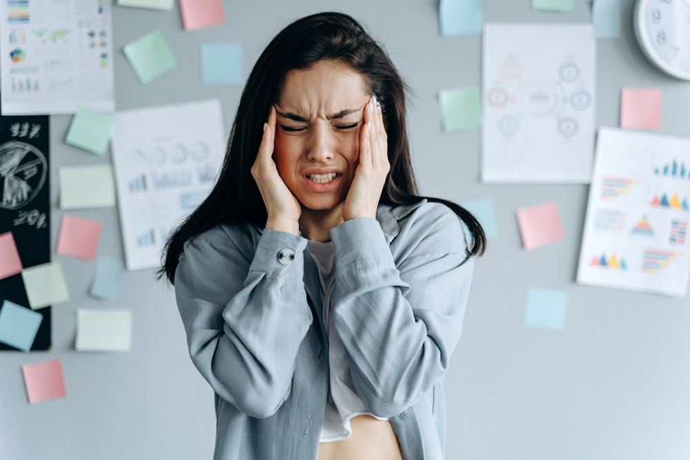 Tired stressed businesswoman feeling strong headache massaging temples exhausted from overwork, fatigued overwhelmed lady. Executive worker suffering from pain in head or chronic migraine in office