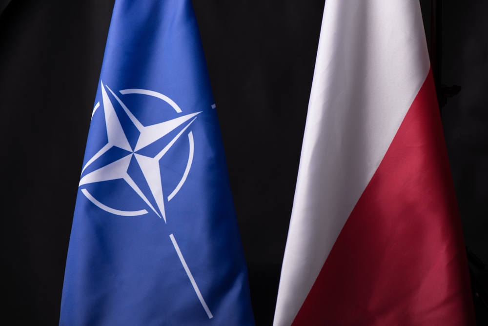 Ukraine, Kyiv - 10.04.2023. The Official Flags of Poland and NATO against black Background. A Symbol of Unity and Resilience in a World of Uncertainty and Conflict.