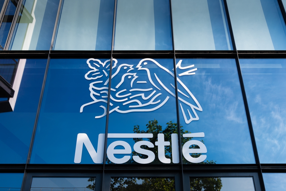 Issy-les-Moulineaux, France - May 18, 2024: Sign and logo on the French headquarters building of Nestlé. Nestlé is a Swiss multinational food and drink processing conglomerate corporation