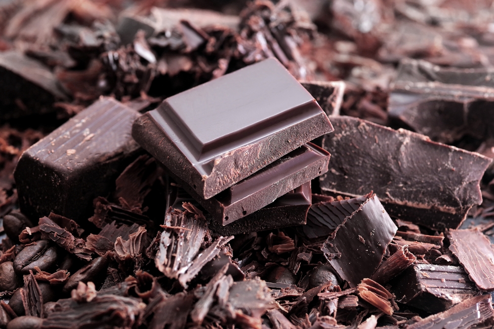 Dark chocolate. Broken chocolate bar on kitchen table