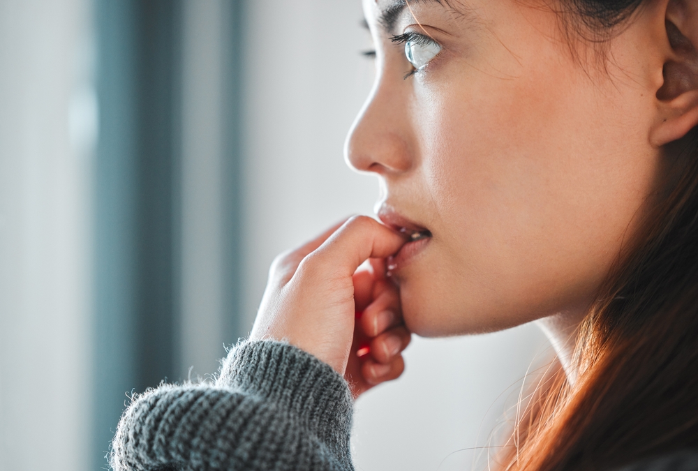 Mental health, woman and nervous of thinking in home with failure, paranoid and regret trauma. Overthinking, person and anxiety in house for ptsd, isolation and victim phobia with stress or wondering