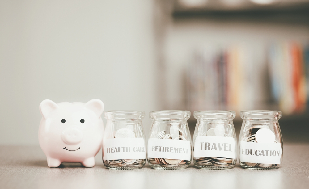 Message on paper and coins in glass jar, piggy bank, all on the table, concept of saving money financial growth preparation after retirement Managing savings for future goals, creating spending habits