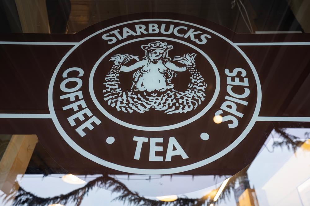 Seattle, WA, USA - Jan 4, 2025: The original Starbucks 1971 logo is seen on the storefront window at the Pike Place Starbucks store in Seattle, also known as the Original Starbucks.