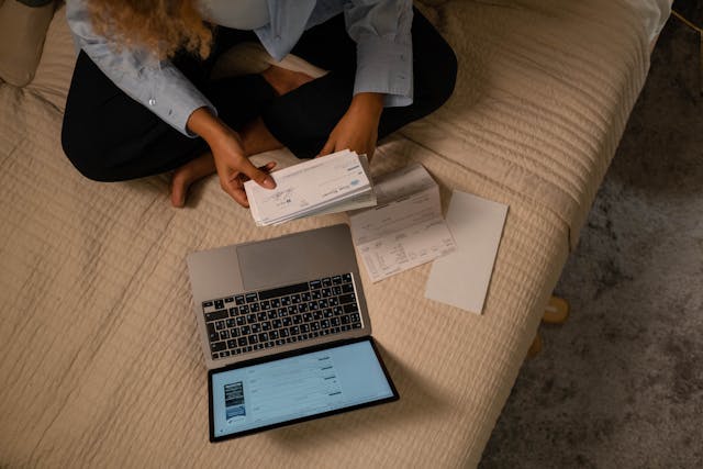 woman with checks and laptop