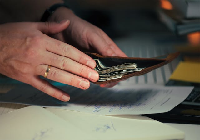 Person putting money in a wallet