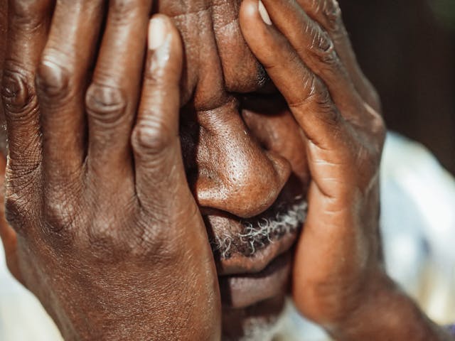 man with head in hands