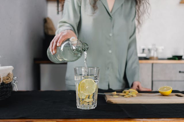 woman pouring glass of water