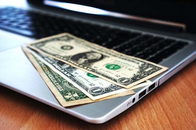laptop and dollars