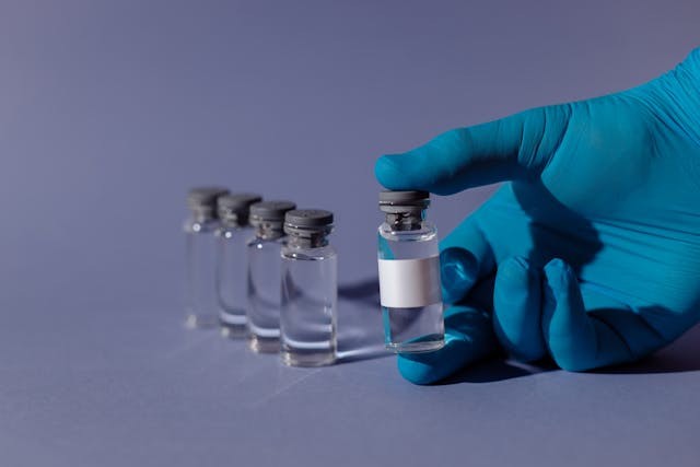 hand holding a vial