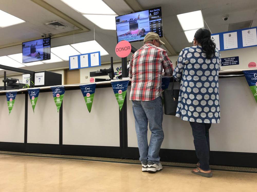 LOS ANGELES, April 25, 2019: DMV Department of Motor Vehicles Culver City interior. Close up of a couple standing at the counter at the DMV field office.