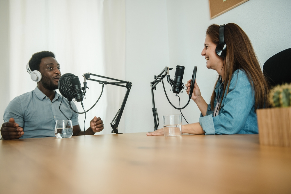 Multiethnic colleagues recording podcast together