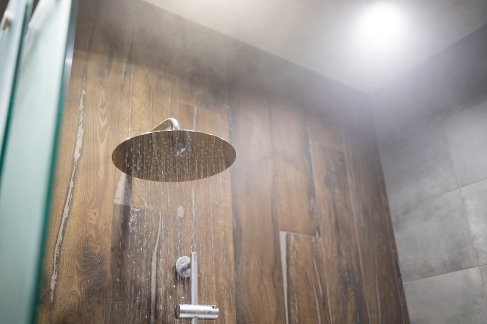 Close up of hot Water flowing from shower in the bathroom interior