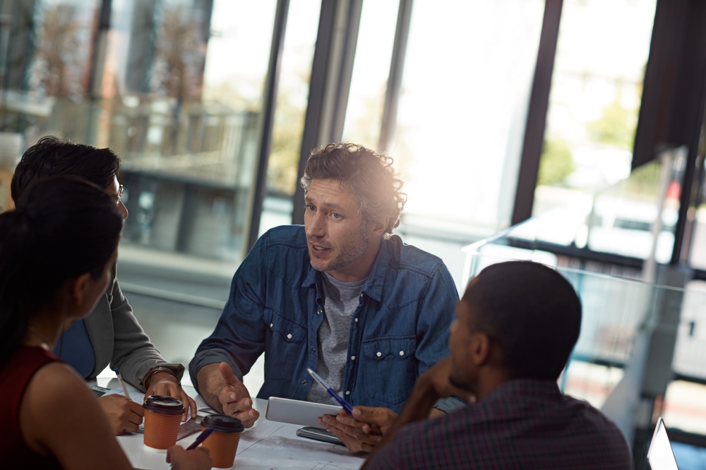 Business people, tablet and diversity in team, meeting or feedback for employee engagement in office. Technology, group and discussion for collaboration, review and communication in creative agency