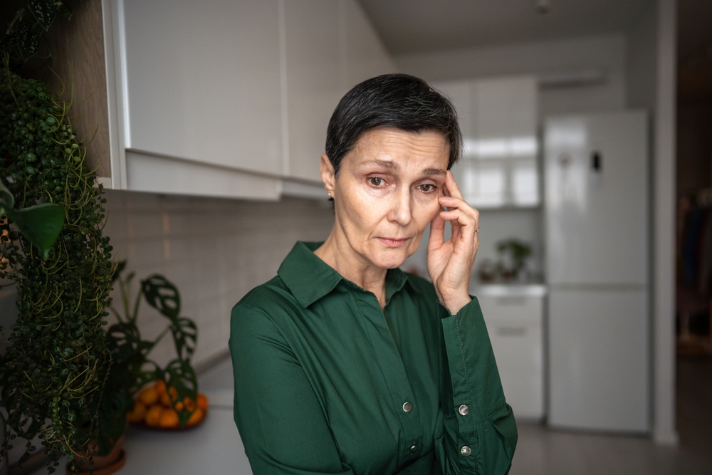 Upset disoriented elderly woman holding temples, headache and memory loss. Cognitive decline, dementia mental confusion, physical and emotional distress, neurological issues, daily life struggle