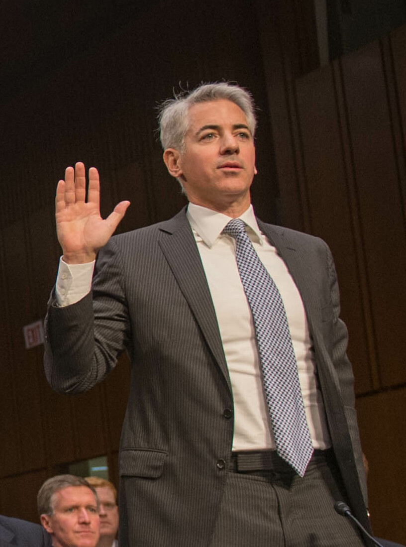 Photography of William Albert Ackman standing and raising his right hand.