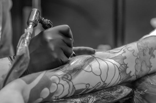 person getting a tattoo on their arm