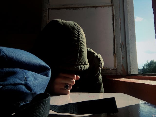 man with head on hand at a table