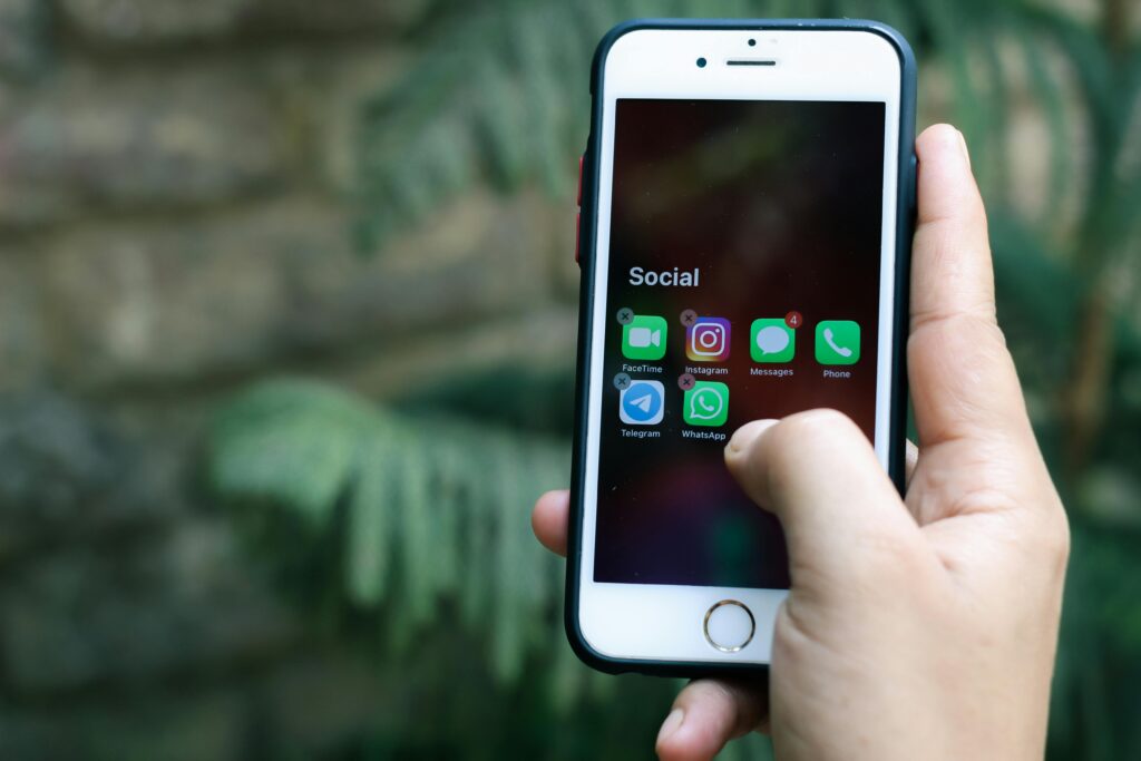 Person Holding White Iphone 6 With Black Case
