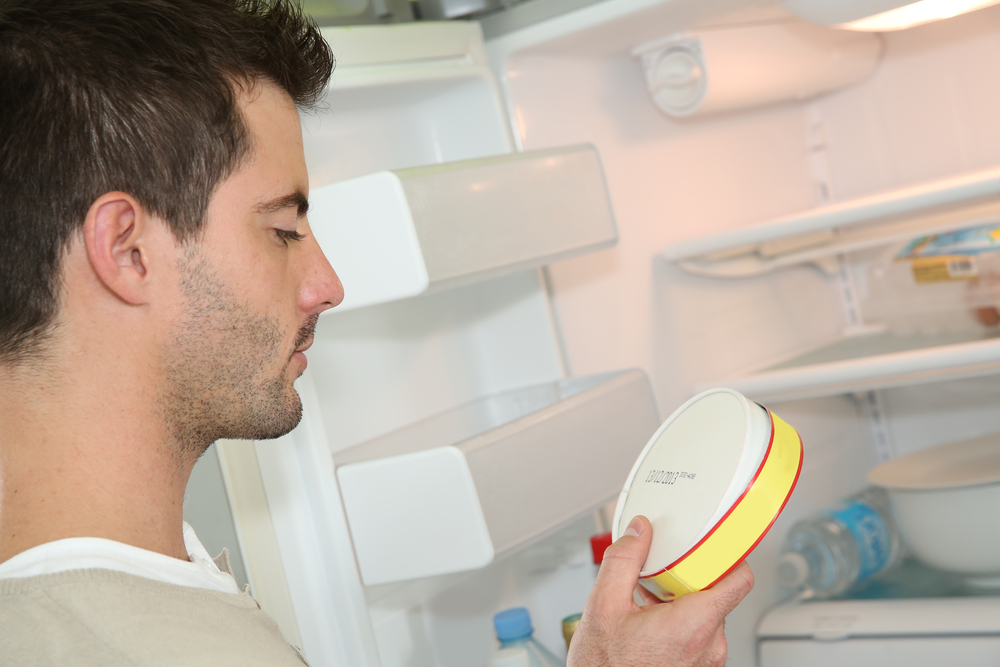 Man looking at expiry date of fresh product