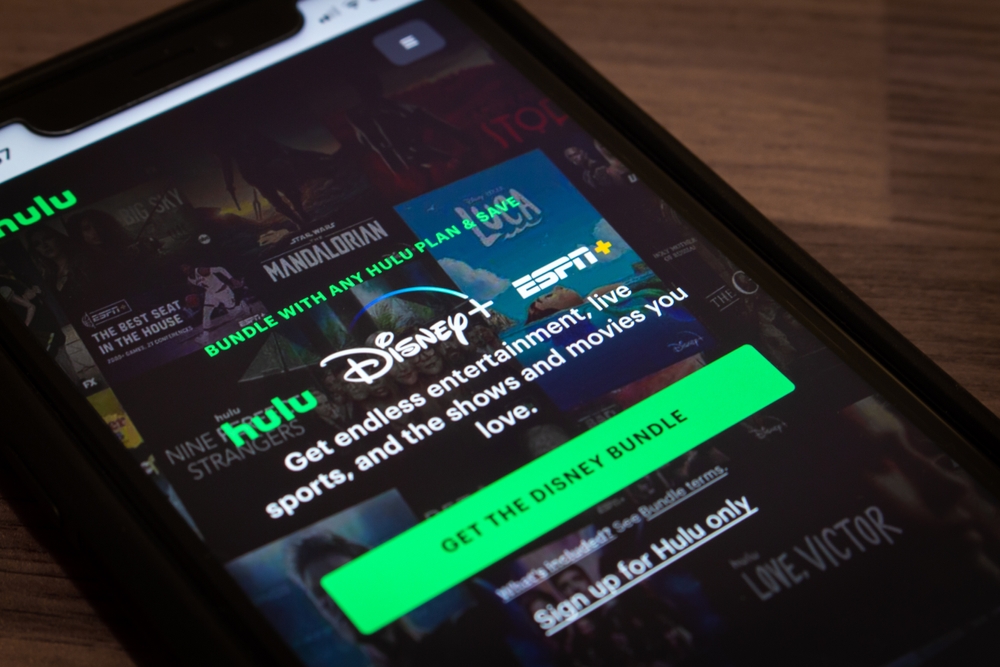 Vancouver, CANADA - Sep 23 2022 : Closeup Hulu website on an iPhone in dark mood. There are Hulu, Disney Plus (Disney+) and ESPN Plus (ESPN+) logos. Big subscription streaming services merger concept