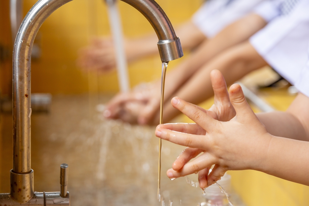 close up hands of children Washing hands with water, copy space for text, clean and Hygiene concept,Coronavirus and Covid-19 concept, Kid washing hands with water at home. Stop corona virus outbreak.