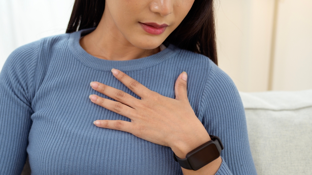 Young female  checking her breast at home , Cancer awareness