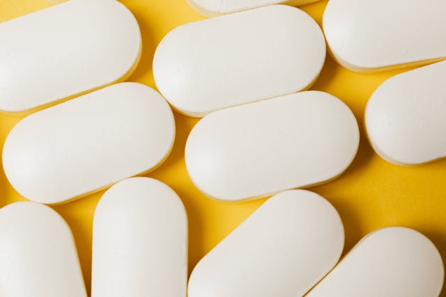 white pilss on yellow background