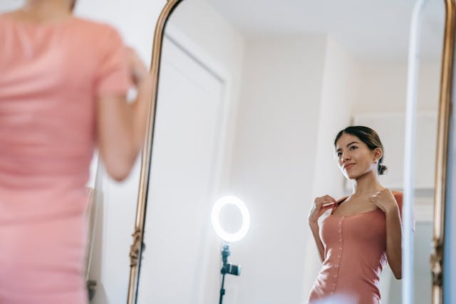 woman looking in mirror