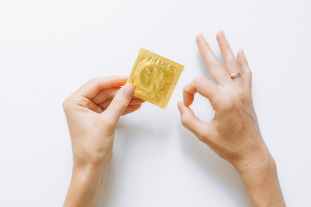 hands holding a condom