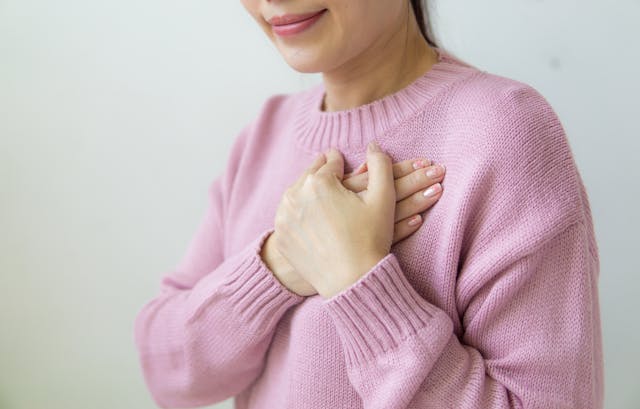 woman holding chest