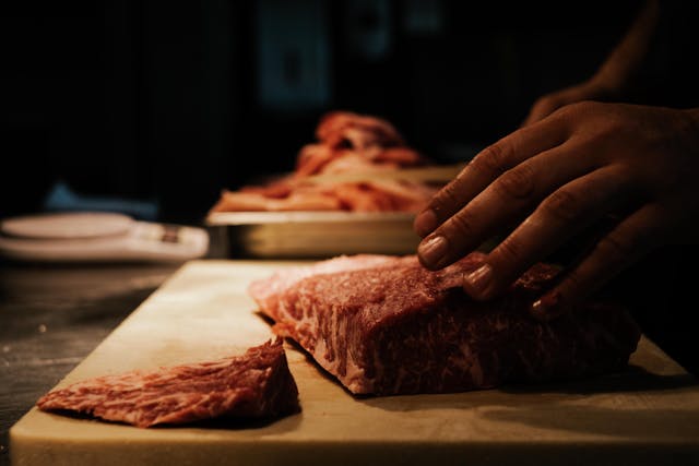 chef cuttting meat