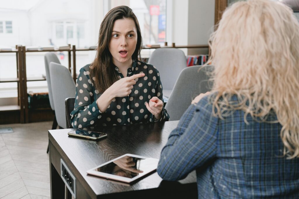 Shocked Woman Poinitng a Finger on her Acquaintance