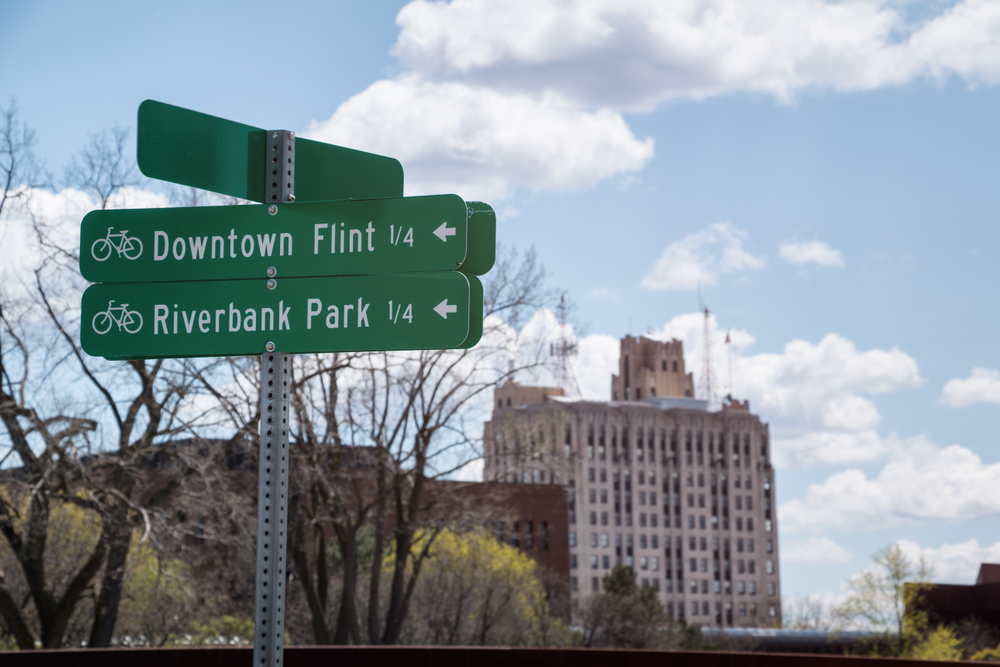 Downtown Flint and Riverbank Park bicycle path direction signs along the Flint River in Flint, Michigan.