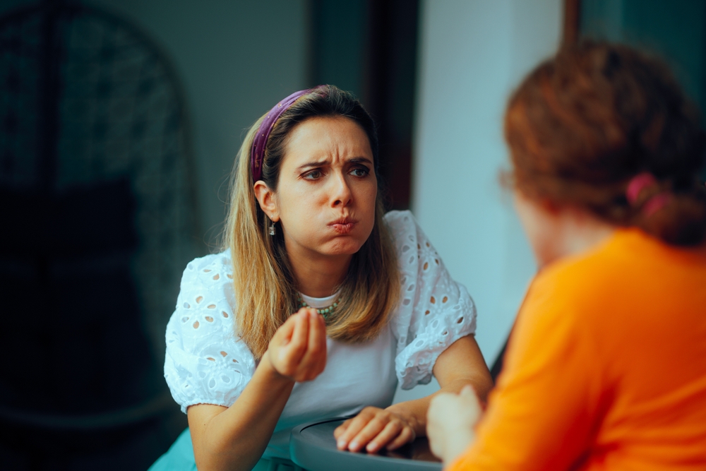 
Women Having a Fight Sitting at Home Discussing. Friends arguing over something important feeling displeased 
