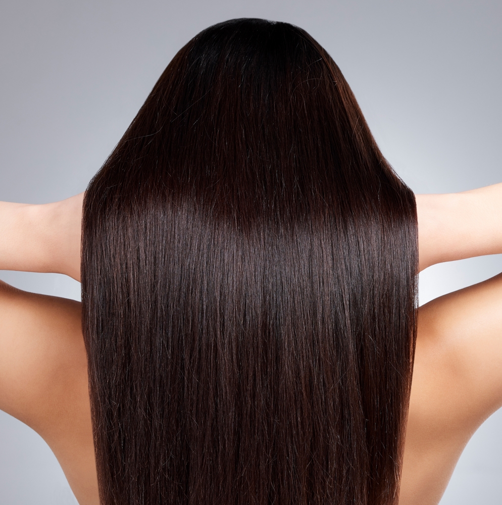 Woman, hair care and back with beauty in studio for healthy growth, keratin treatment or straight hairstyle aesthetic. Female person, wellness and collagen shine, cosmetics and white background
