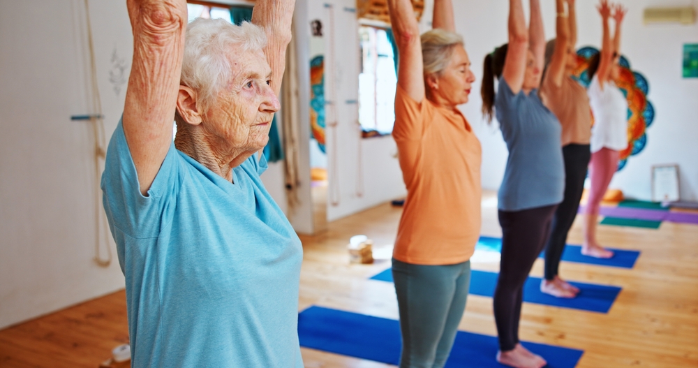Group, senior people and stretching for yoga for zen, fitness exercise and spiritual wellness. Elderly women, muscle warm up and pilates lesson, community and holistic for body balance at health club