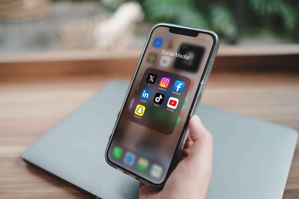 Bangkok, Thailand. June 23, 2025; A smartphone screen displaying a folder of popular social media apps, including X, Instagram, Facebook, TikTok, YouTube, LinkedIn, and Snapchat.