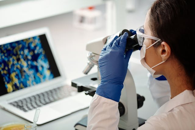 Researcher looking through microscope