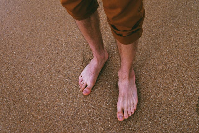 man standing on sand