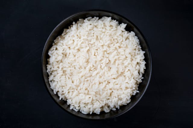 Rice in a bowl, black background