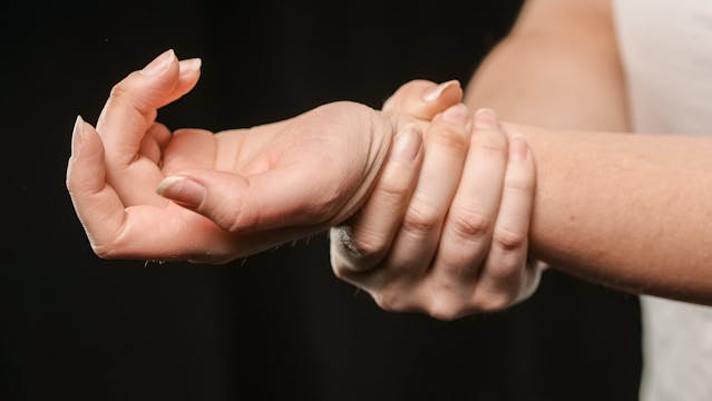Hand holding wrist
